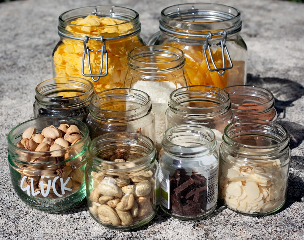 clear glass jars with white and brown stones
