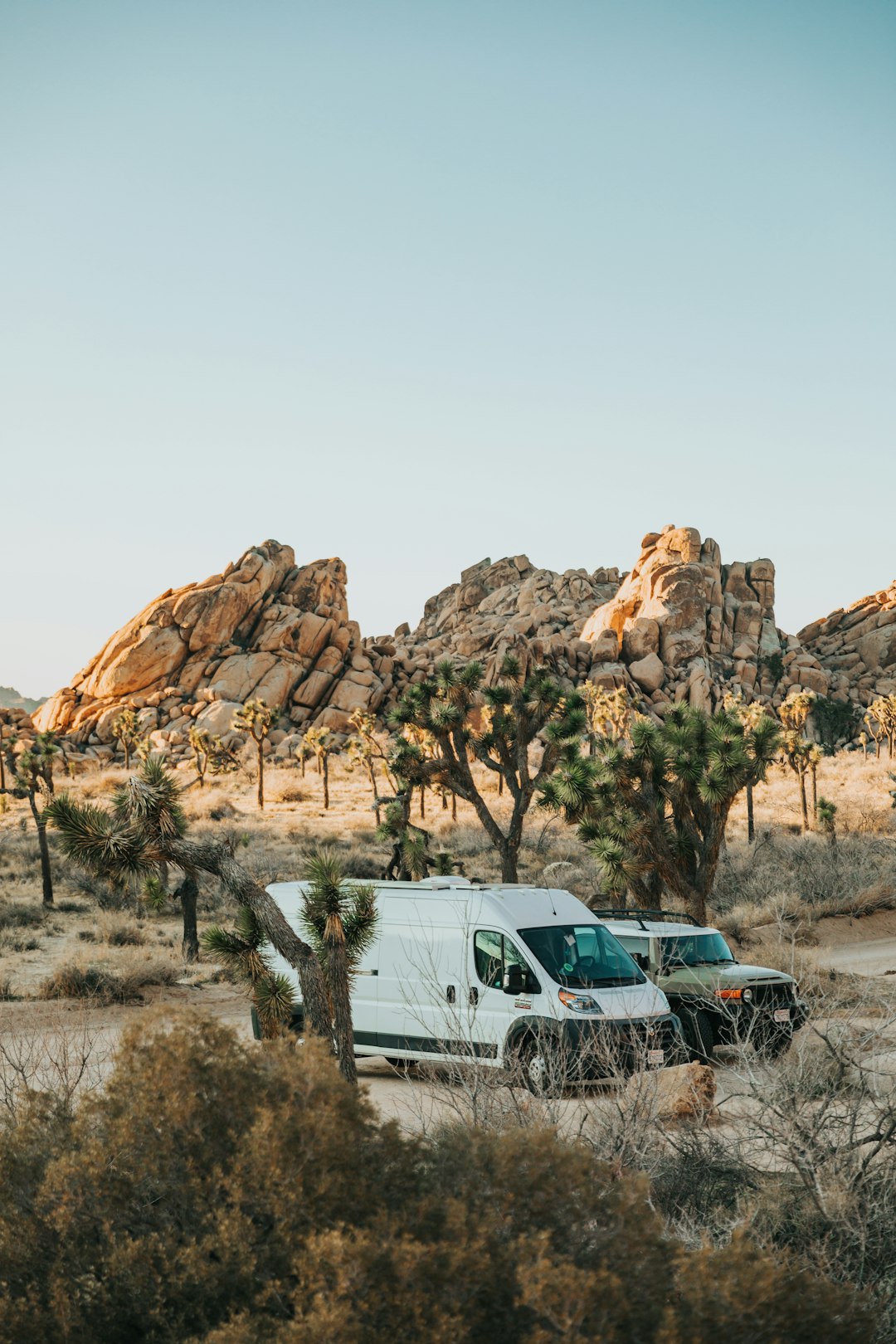 white van near brown rock formation during daytime