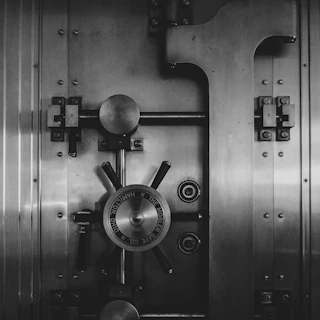 Close-up of a Mosler Safe Co. vault door handwheel and brushed-metal locking hardware