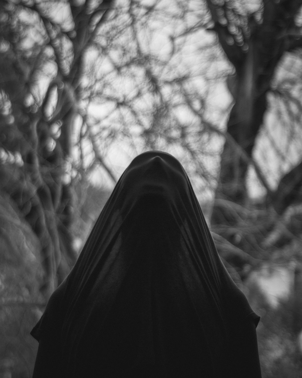 grayscale photo of person in black hijab