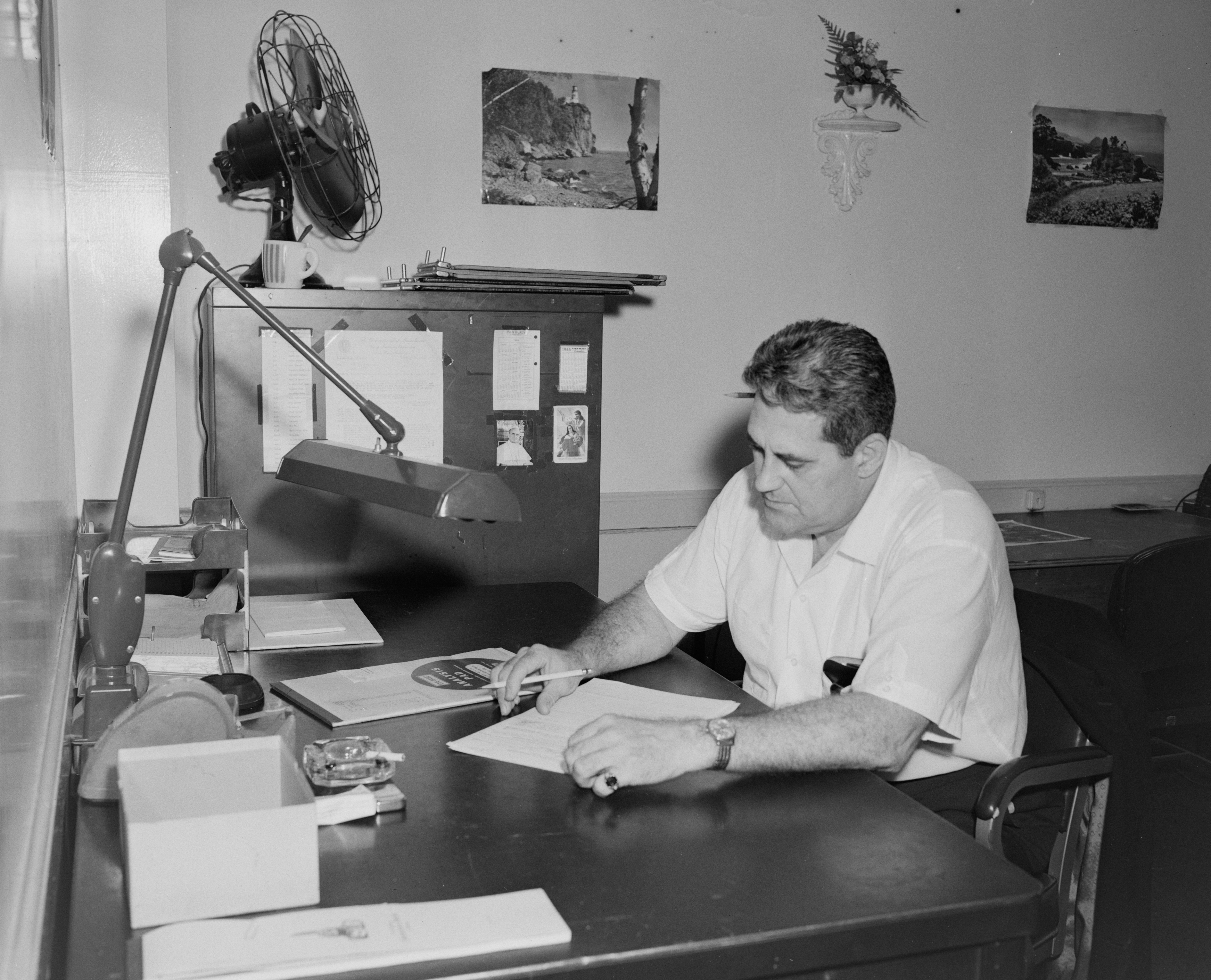 man in white button up shirt sitting at the table