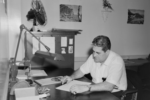 man in white button up shirt sitting at the table