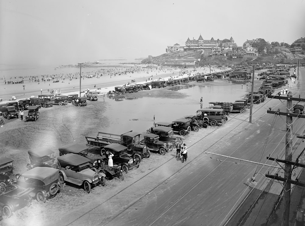 grayscale photo of people on beach