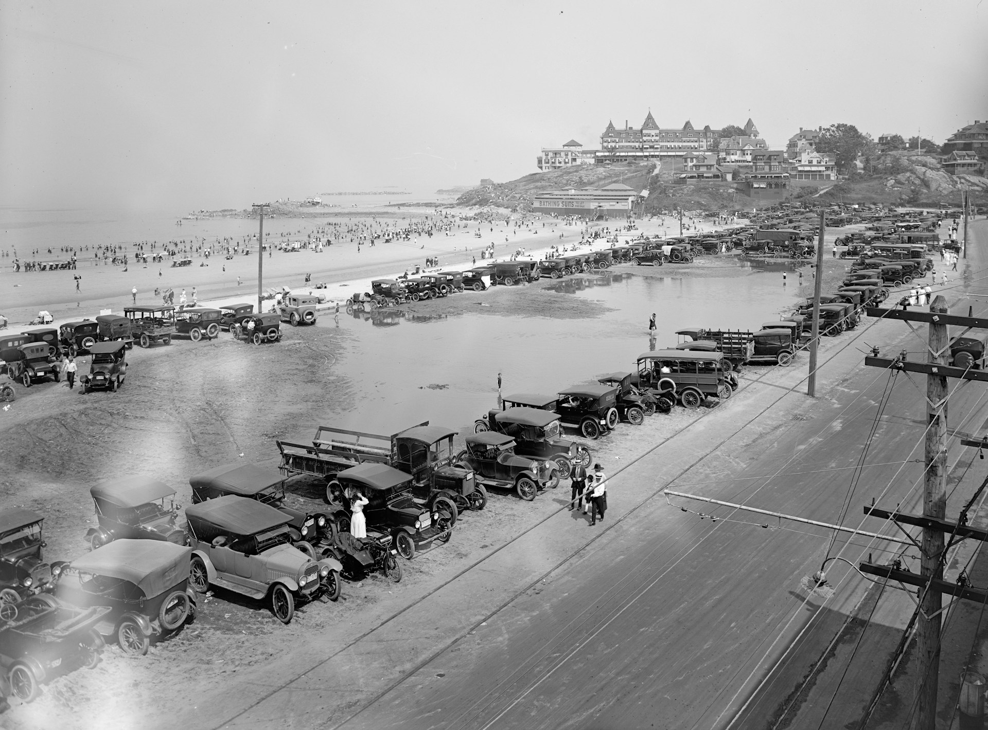 grayscale photo of people on beach