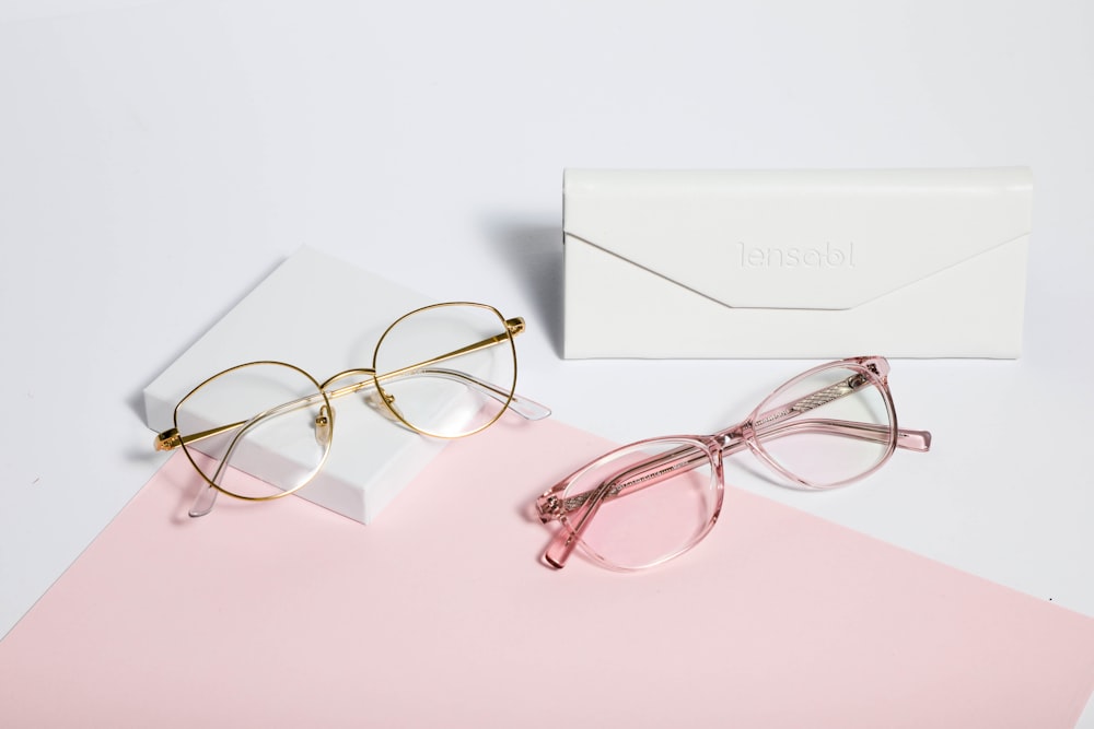 gold framed eyeglasses on white paper