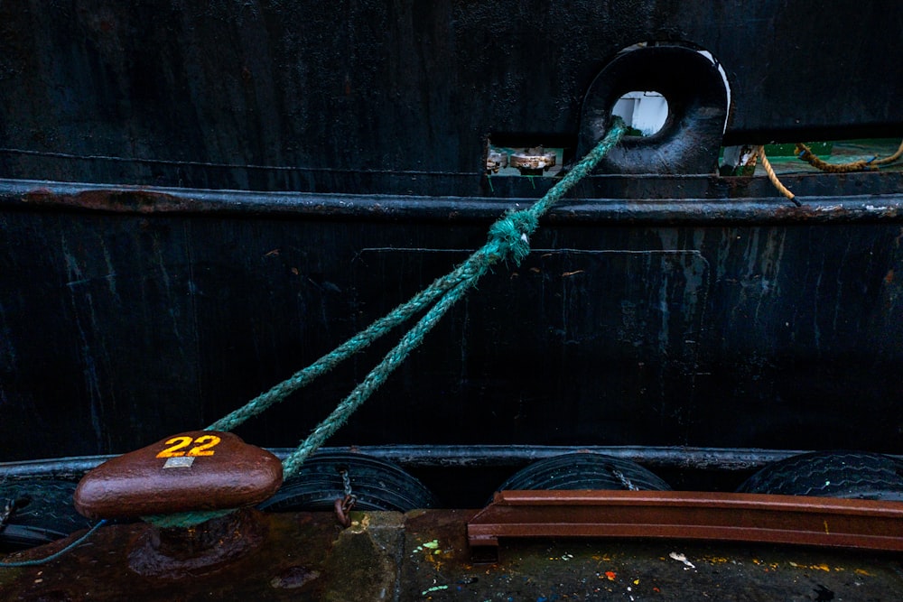 green rope tied on brown wooden board