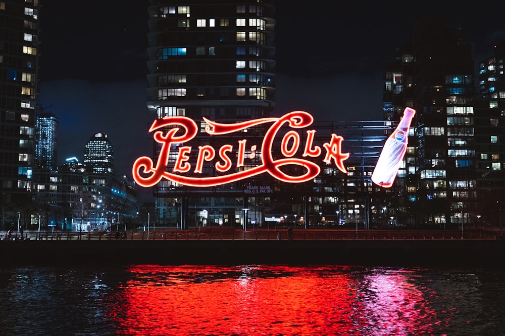 red and white flag on top of building during night time