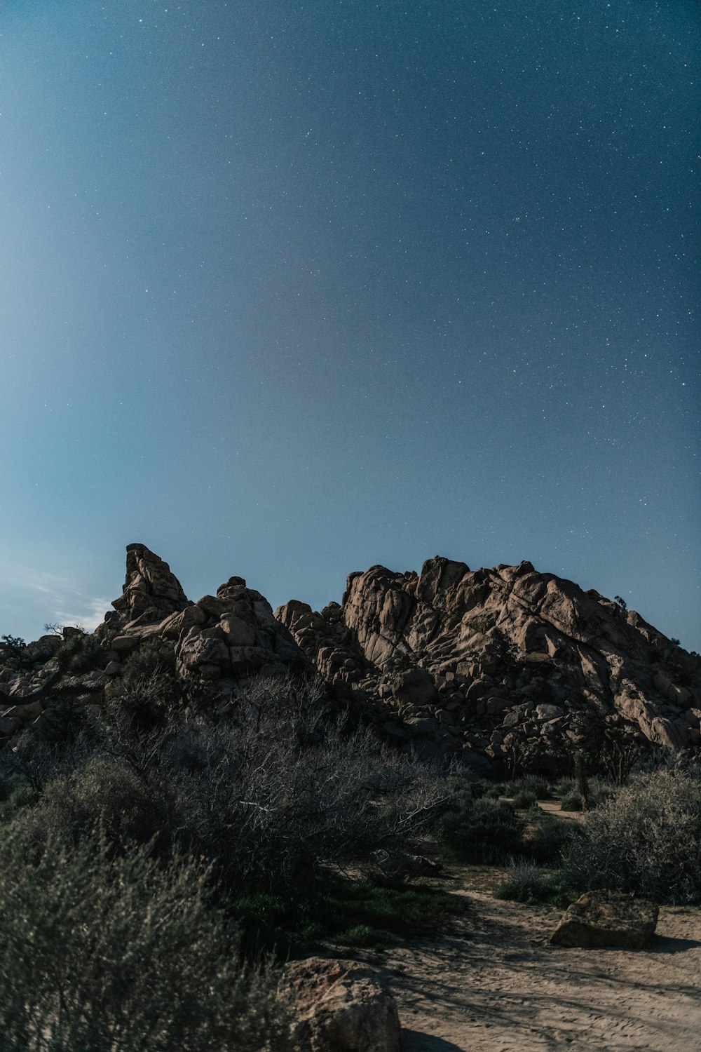 brown rocky mountain under blue sky during night time