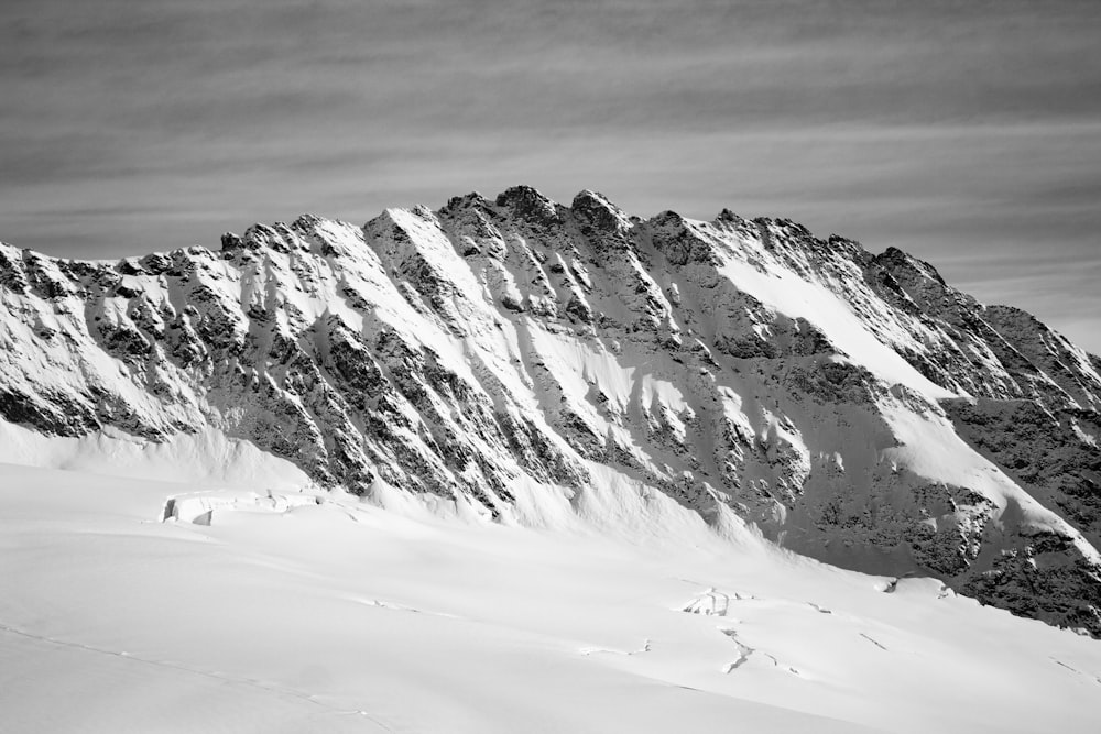 snow covered mountain under cloudy sky during daytime