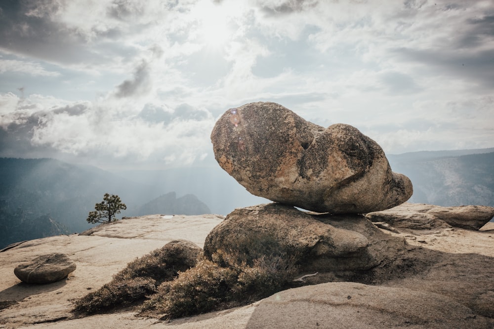 brown rock formation under white clouds during daytime