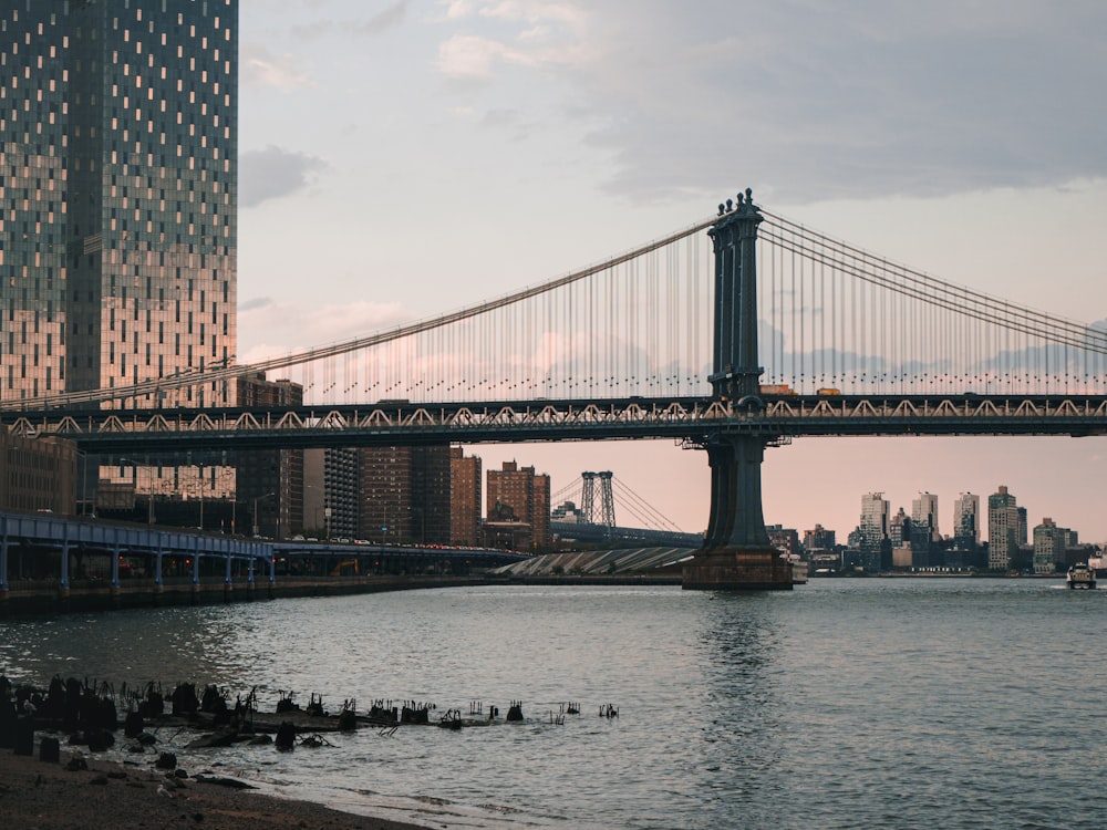 bridge over water under cloudy sky during daytime