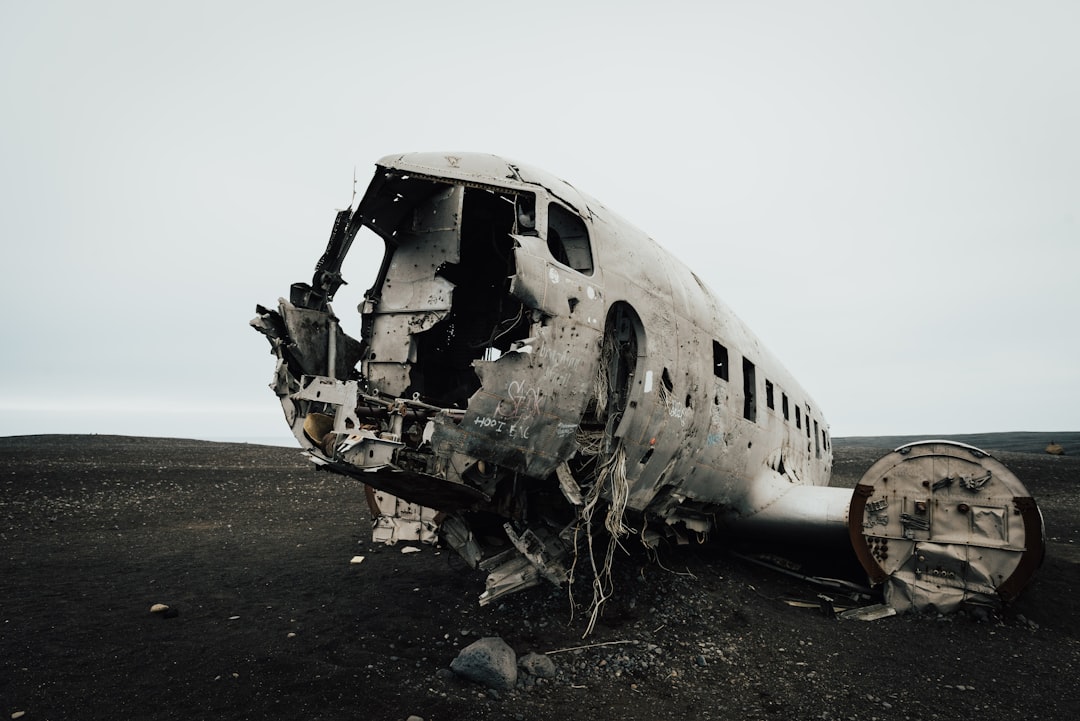 wrecked airplane on gray sand during daytime