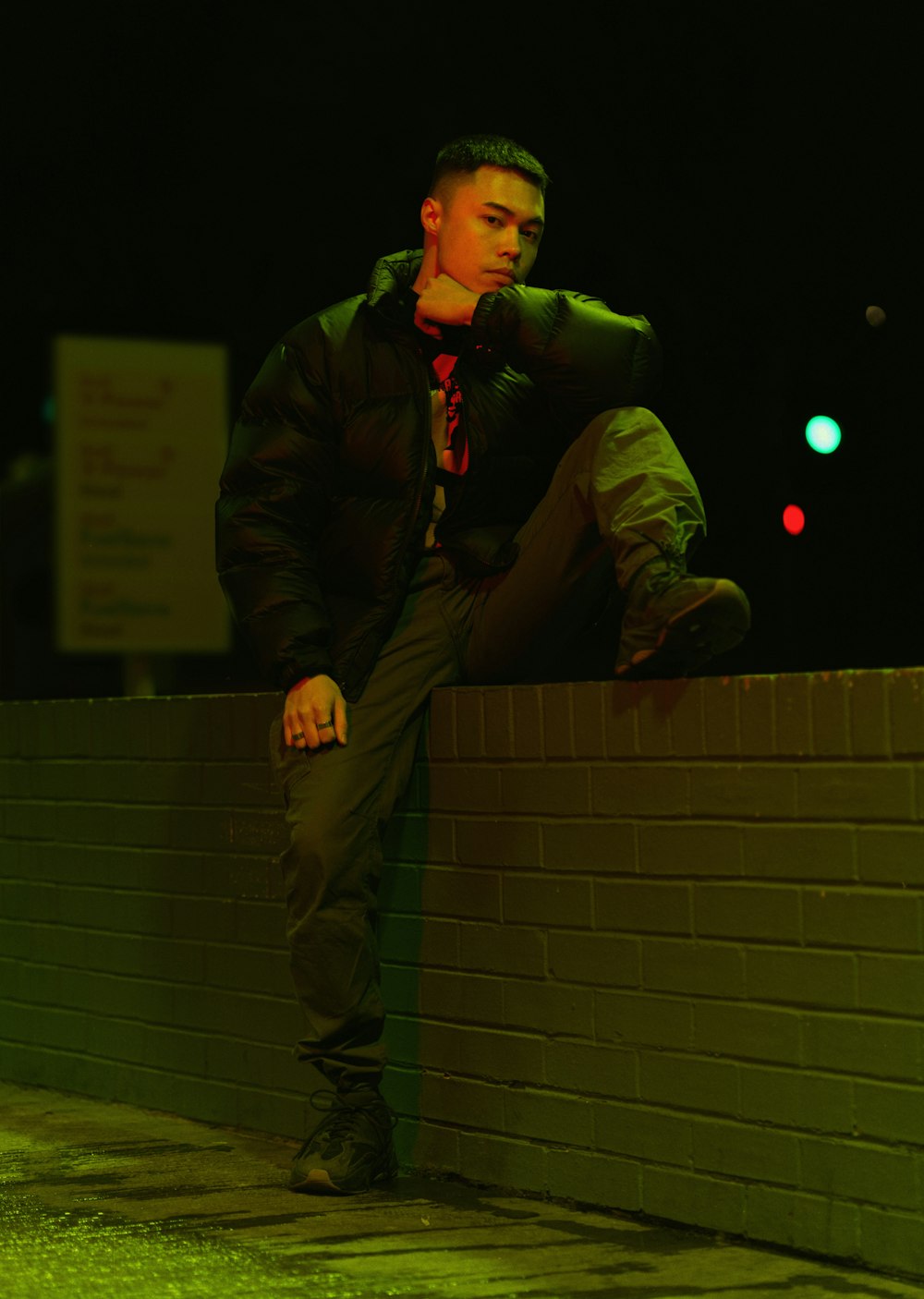 man in black jacket and brown pants standing on stairs