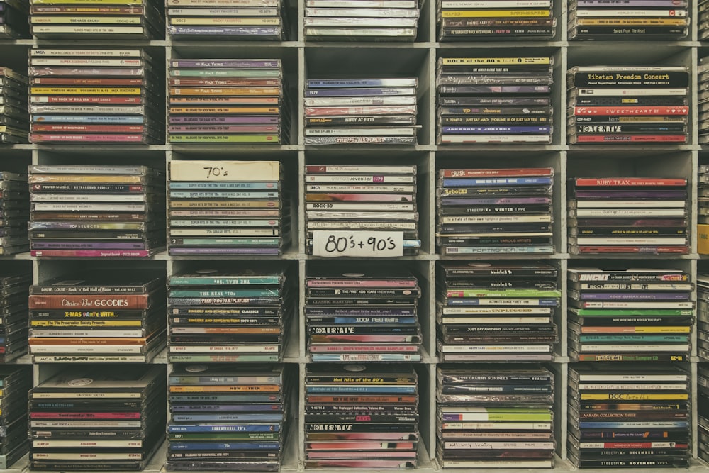 assorted books on black wooden shelf