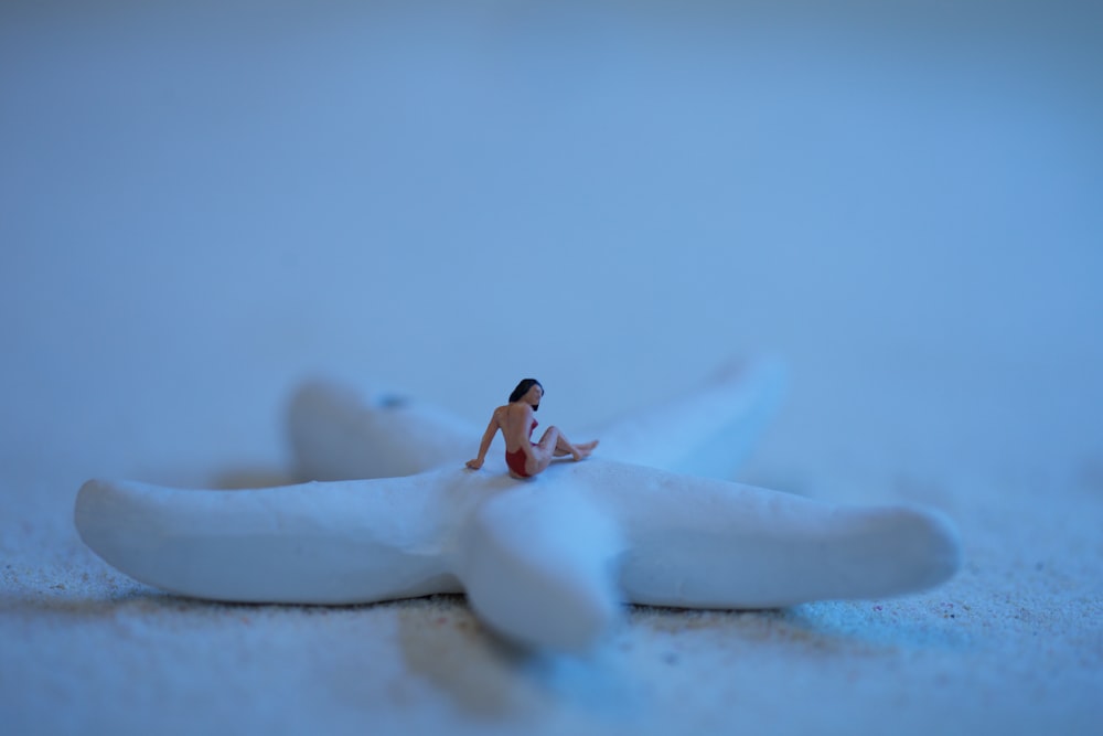 woman in black bikini lying on white snow