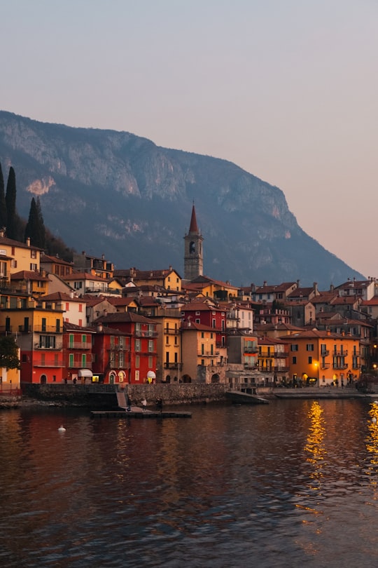 brown and white concrete buildings beside body of water during daytime in Varenna Italy
