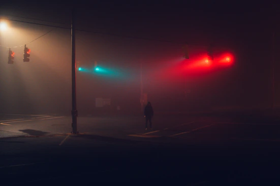 A misty, eerie ghost town street at twilight with shadowy figures watching from the corners.