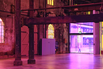 Construction workers remodeling an industrial workspace with bright colors