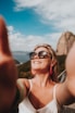 woman in white tank top wearing black sunglasses