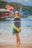woman in blue and yellow dress standing on beach during daytime
