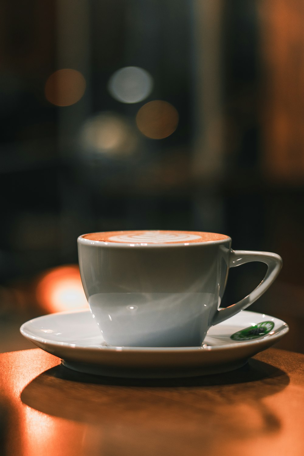 white ceramic cup on white ceramic saucer