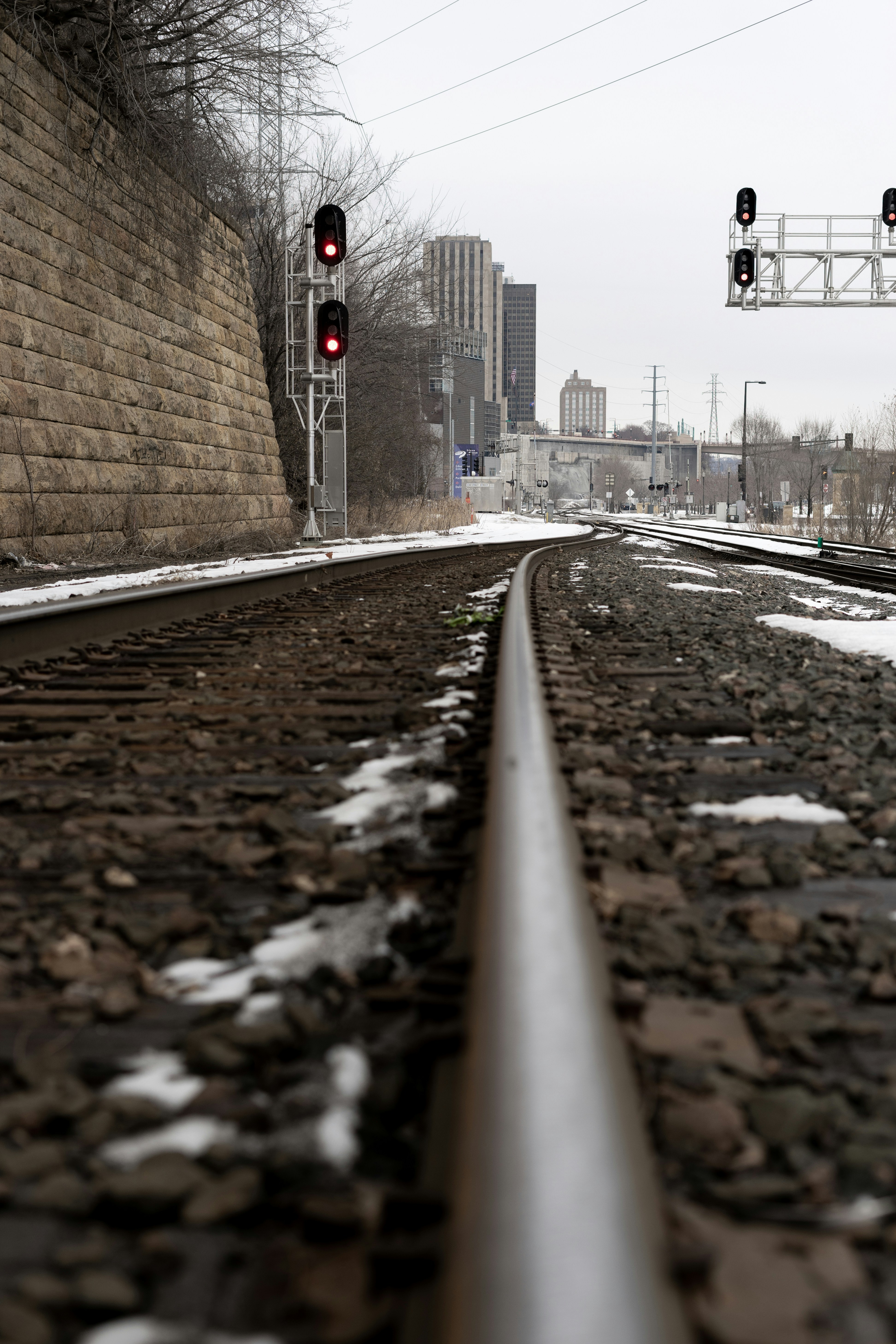 train rail near brown brick wall