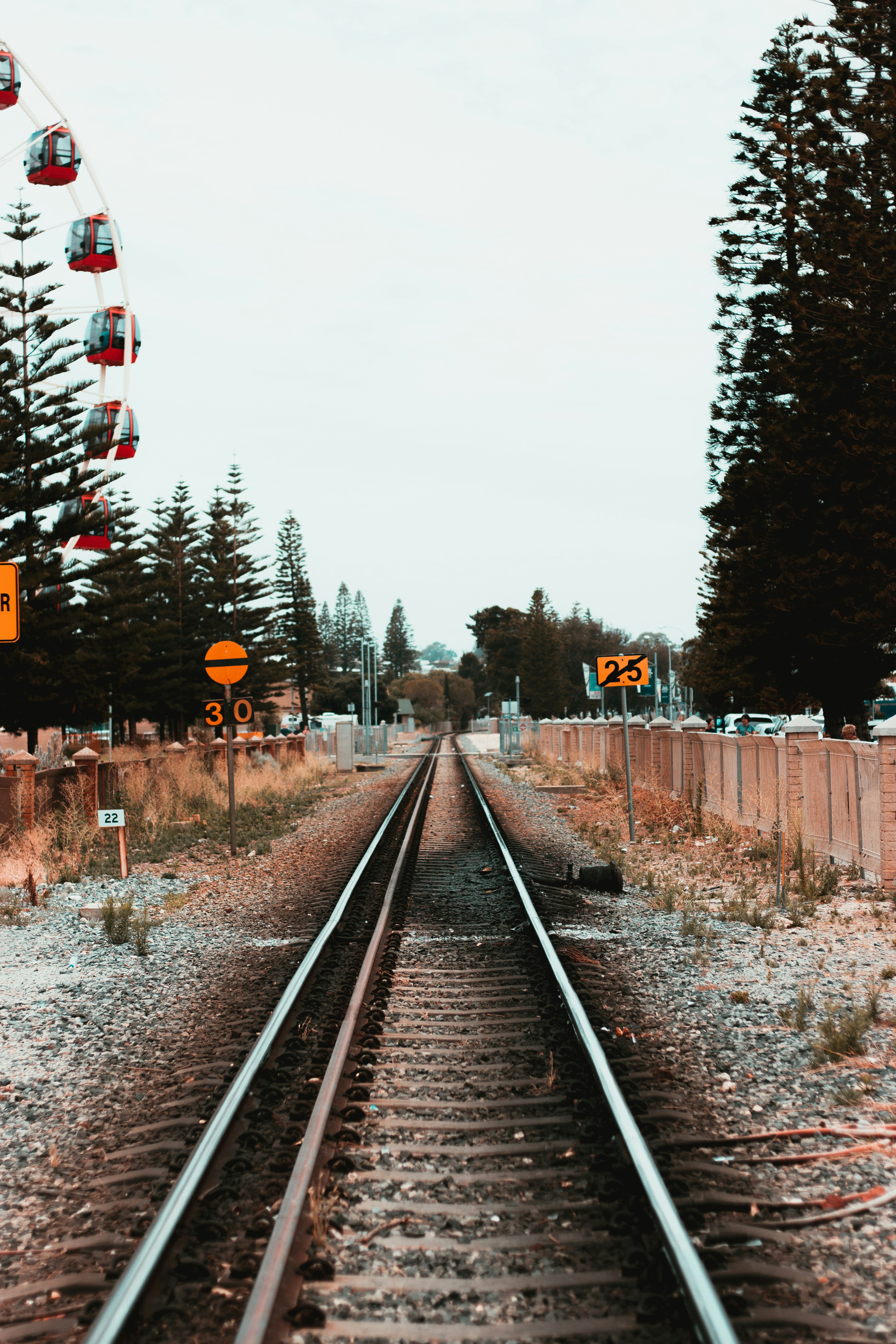 train rail near trees during daytime