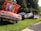 red and black vintage car on green grass field