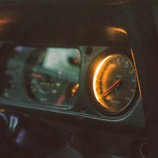Close-up of the electric orange Kenwing Cruiser’s dashboard glowing in the evening light