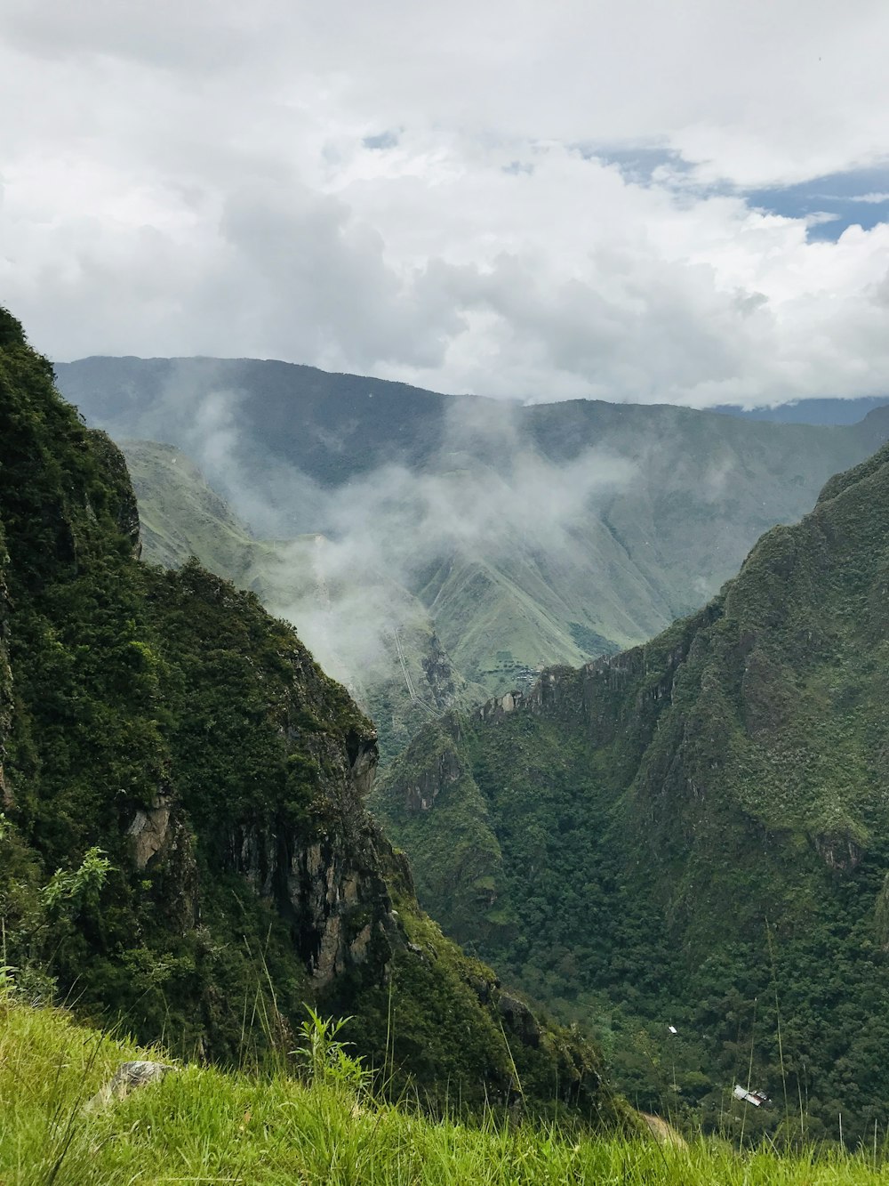 green mountain under white clouds during daytime