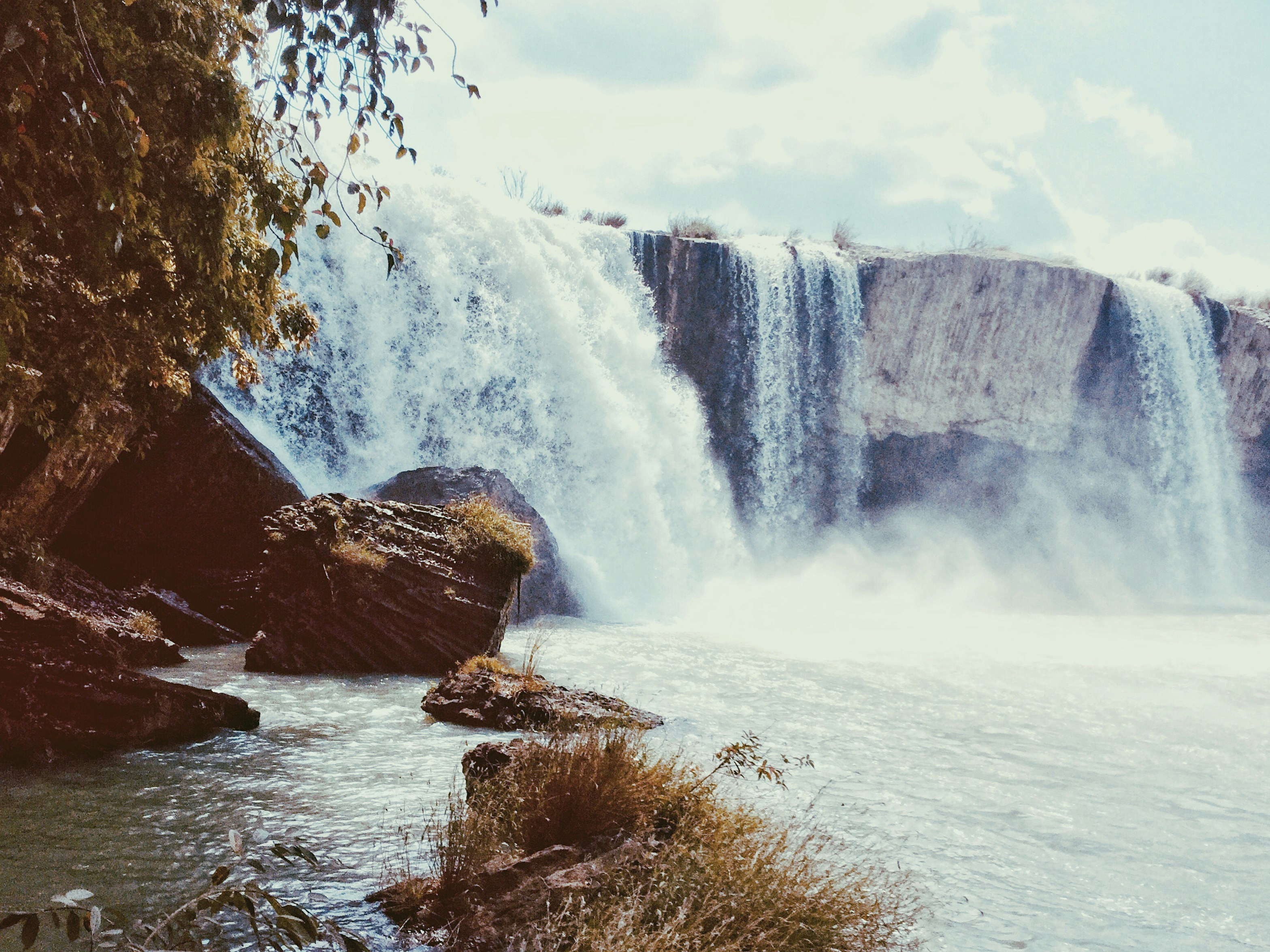brown rock formation near waterfalls during daytime
