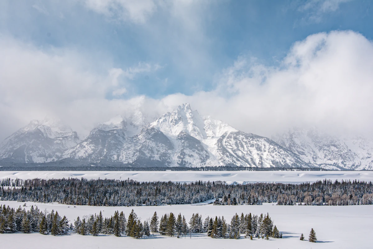 Snow-covered Teton range rising above a winter valley in Wyoming
