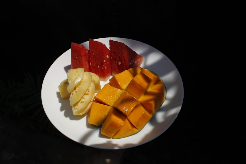 sliced fruit on white ceramic plate