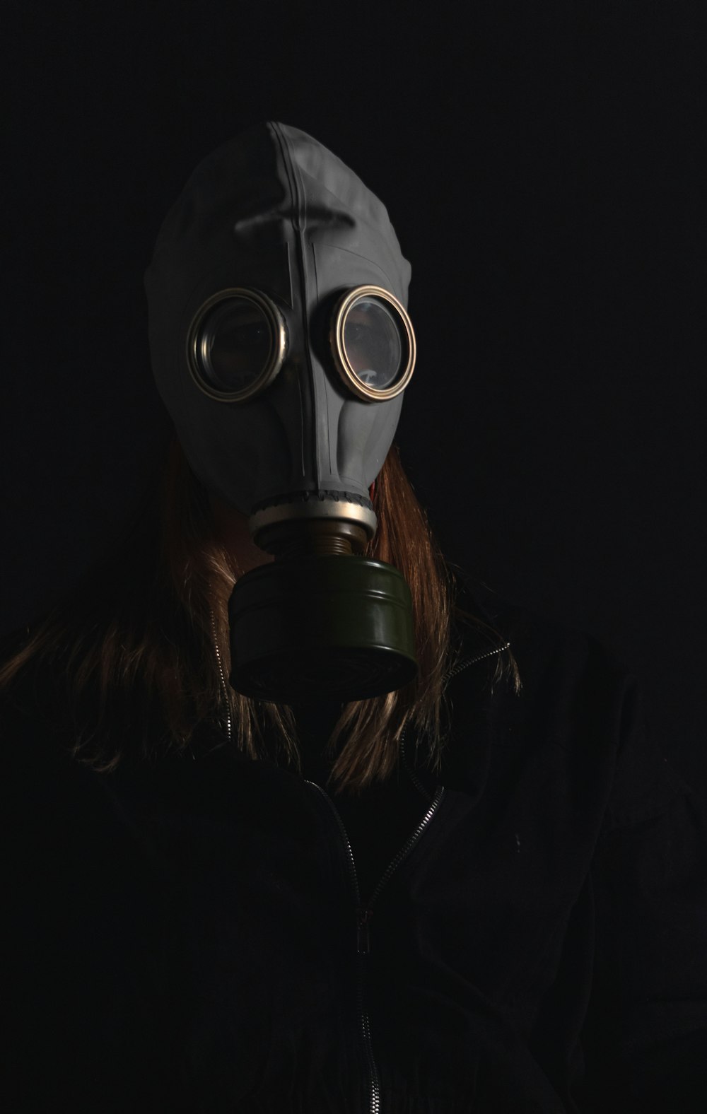 person wearing black gas mask