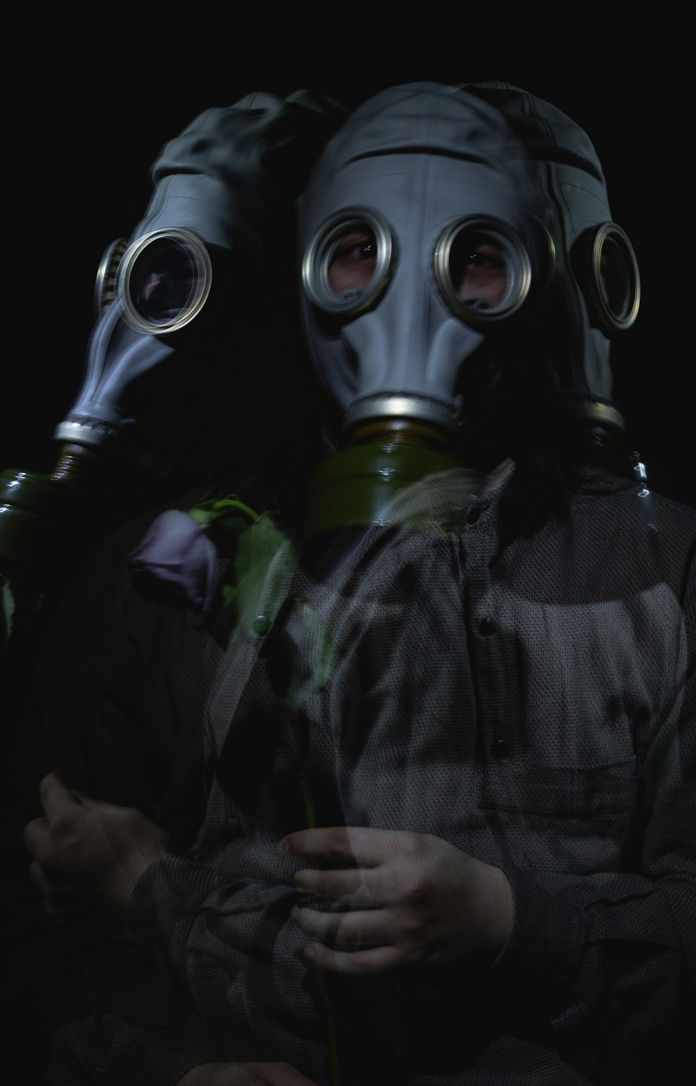 person wearing black and green gas mask