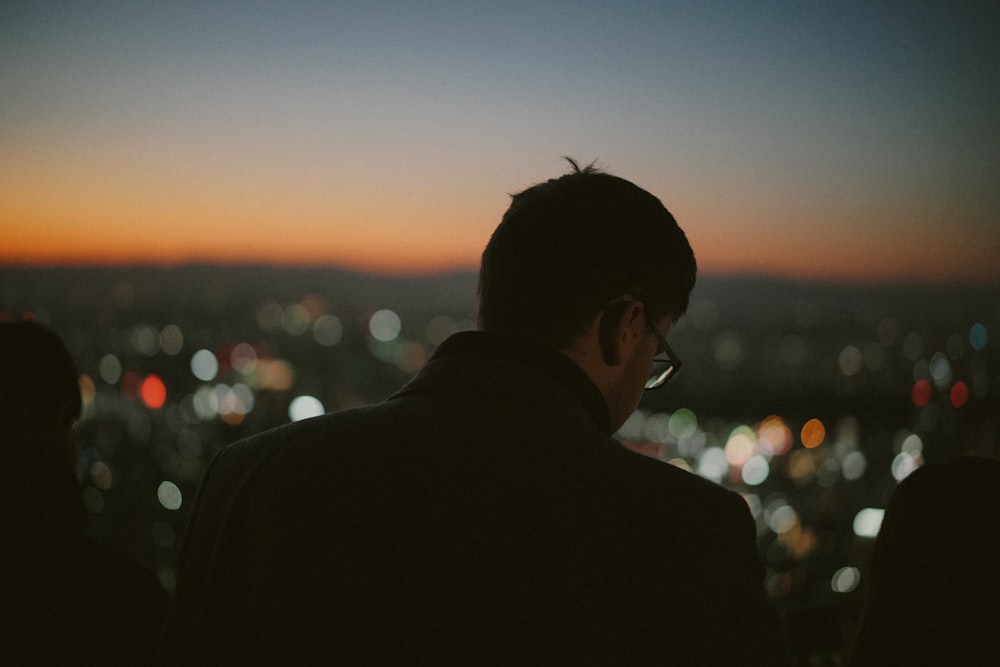 man in black suit jacket during sunset