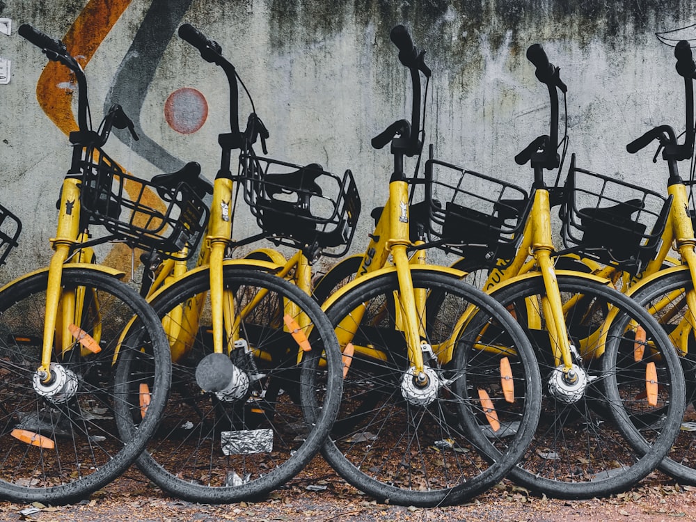 yellow and black bicycle leaning on wall