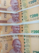 two 20 and one 50 indian rupee banknotes