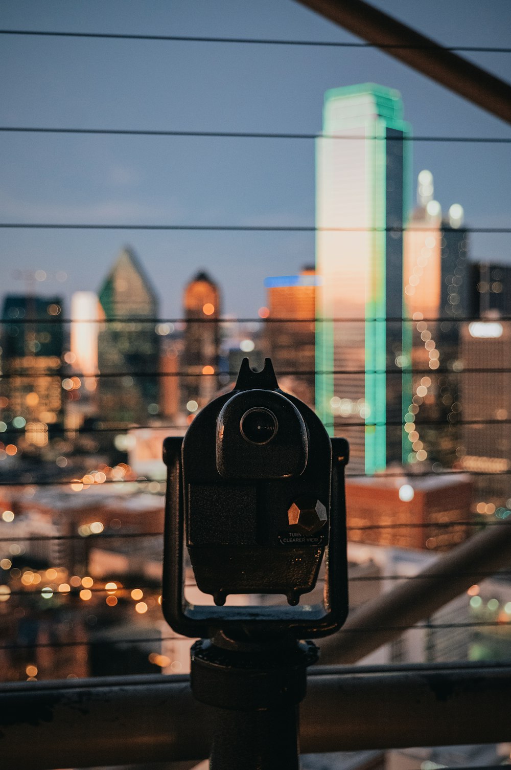 black camera on black metal fence during daytime