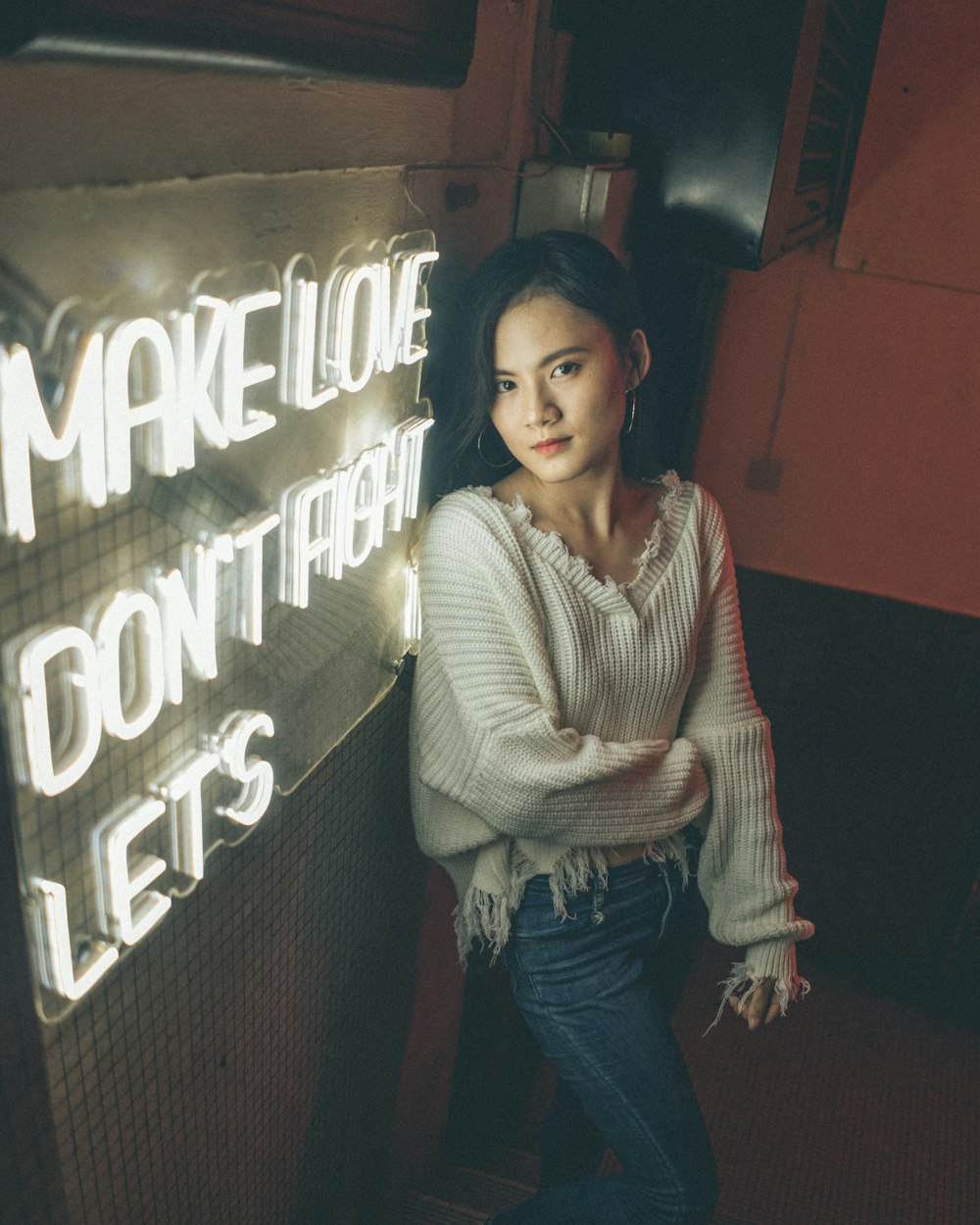 woman in white and brown striped sweater and blue denim jeans