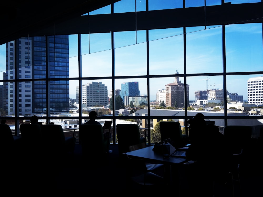 people sitting on chair near glass window