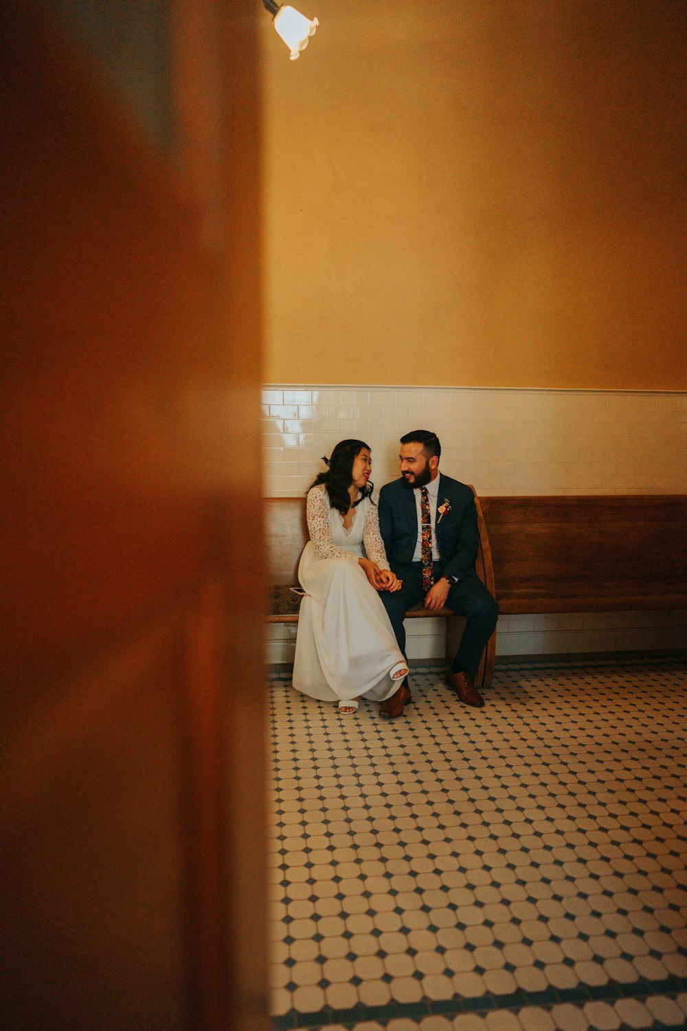 man and woman standing on brown wooden hallway