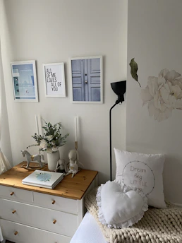 A cheerful bedroom corner decorated with creative household items and playful wall decals.