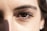 Close-up of perfectly laminated eyebrows with a subtle tint under soft lighting.