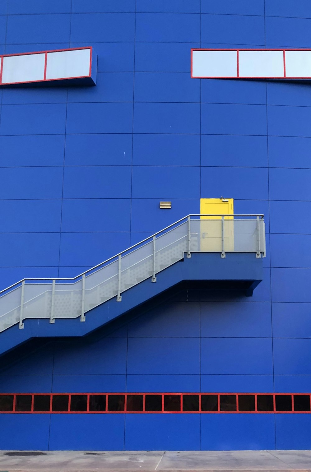 white and blue building with blue wall