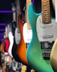 white and orange electric guitars