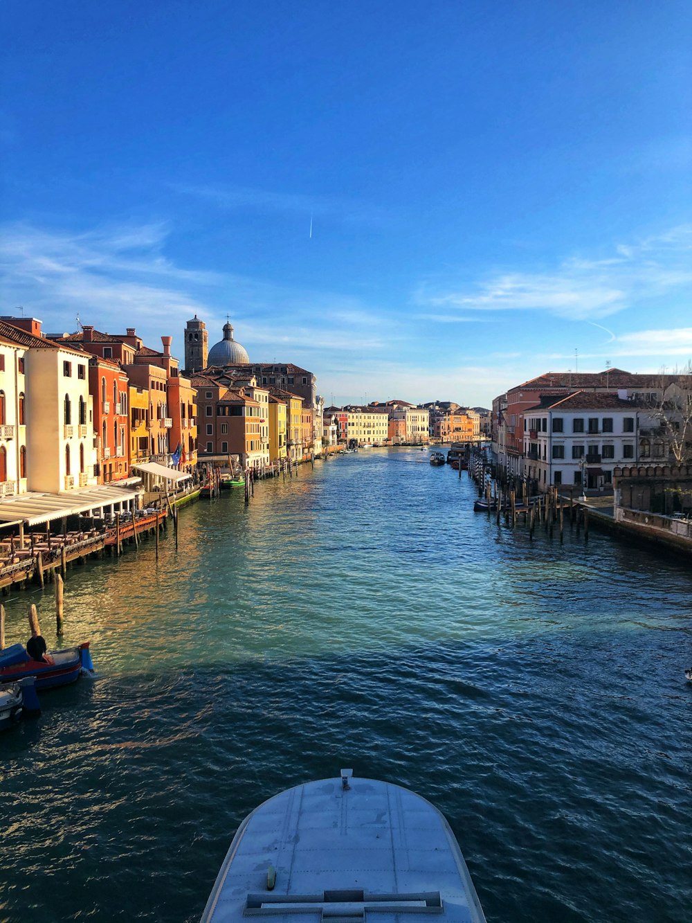 boat on river between buildings during daytime