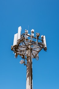 white and black satellite dish on top of white building