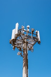 white and black satellite dish on top of white building