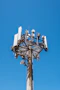 white and black satellite dish on top of white building